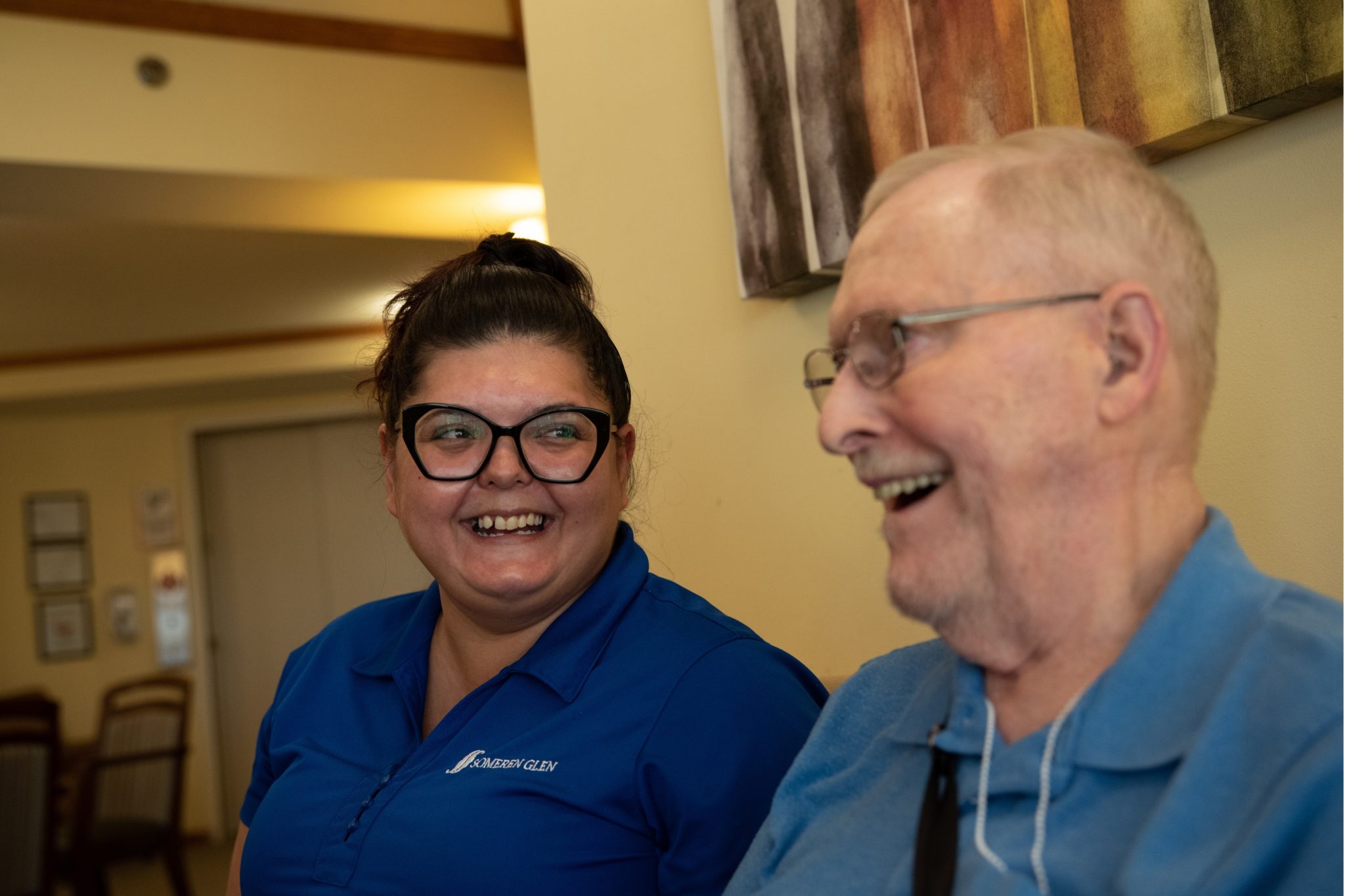 Someren Glen Senior Living Community in Centennial, CO - team member and older man laughing together largelandscape